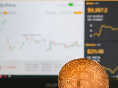 gold bitcoin coin against blurred background with crypto currency exchange rates. virtual money market trade conceptの写真素材