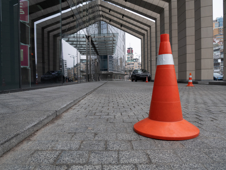 parking cone white and orange near building at the city downtownの写真素材