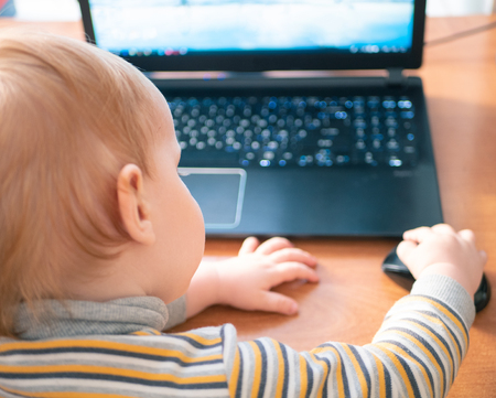 little caucasian white boy child learning alphabet on laptop computer press button on mouse. study...