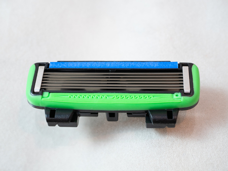 macro close-up of safe replaceable shaving razor blade refill cartridge on white background. horizontal object layoutの写真素材