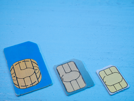 three sim cards standart, micro, nano 4g lte 5g ready on blue background. low angle shotの写真素材