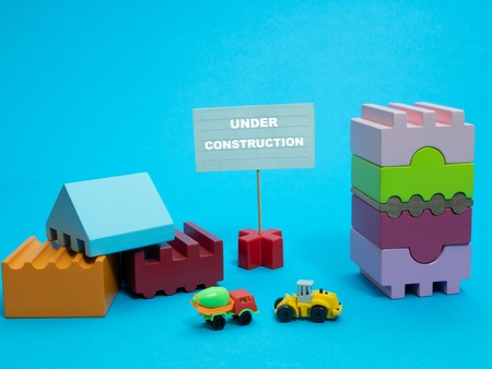 small sign stand under construction among builder toys. any occupation almost done concept. work, development, internet web siteの写真素材