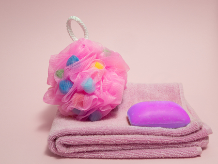 set of shower spa goods for woman - pink towel, funny colored sponge, soap with lavender extractの写真素材