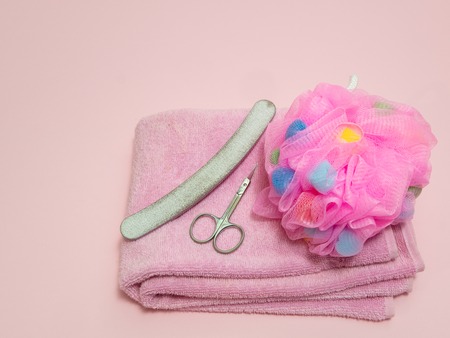 home manicure or pedicure home tool kit- towel, sponge, scissors and nail file on pink backgroundの写真素材