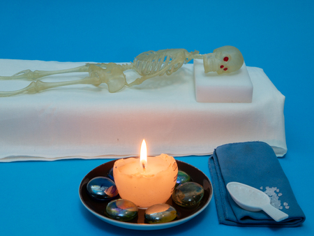 concept of body spa massage beauty salon. human skeleton on table covered with white clothの写真素材