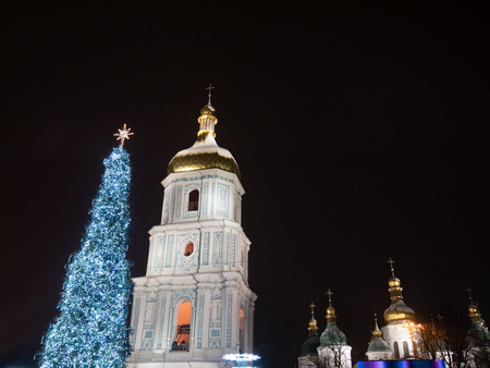 KYIV, UKRAINE - DECEMBER 30, 2018: Christmas tree at St. Sophia square with Bell tower and golden domes of Sofia Monastery at nightのeditorial素材