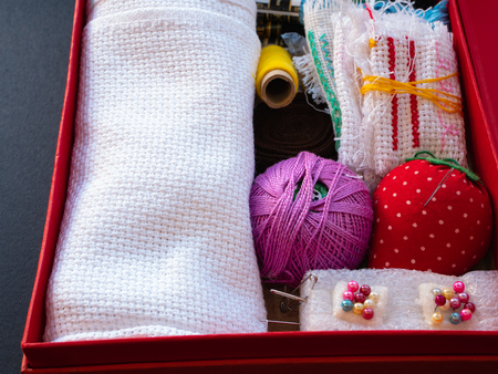 box with needlework equipment like needles, threads, pins, tissue, textile, cloth, fabric for craft handmadeの写真素材