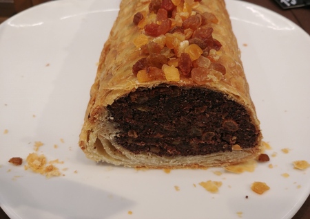 homemade poppy seeds layer cake with dried fruits on top. freshly baked dessert on white plateの写真素材