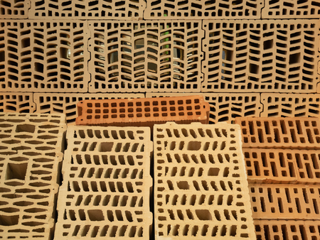 many different types of construction hollow bricks with patterns inside. samples for sale at diy store warehouse depotの写真素材