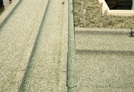 closeup of building wall with insulating  , concrete cement and small stonesの写真素材