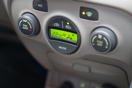 car interior design panel with led indicators, LCD display show temperature , buttons and dials for climate control. High quality photoの写真素材