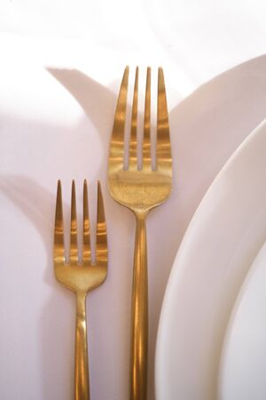 Luxury cozy autumn wedding table decoration in the restaurant. Fresh and dried flowers, roses, carnations. Beautiful table setting: golden appliances, fork and knife.の写真素材