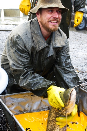 The figure of the fisherman and the catch pond.のeditorial素材