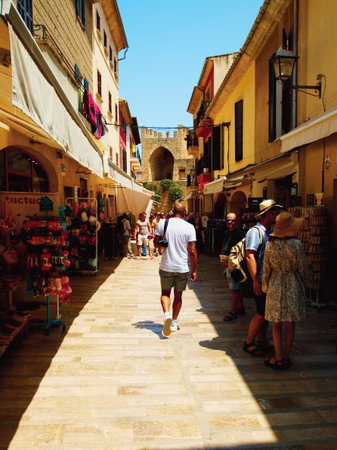 People in the streets of the old town in the city of Alcludia on the island of Mallorca in the Balearic archipelago in the Mediterranean Sea. Spain.の写真素材