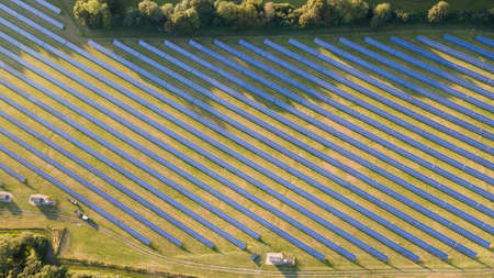 Solar power farm in the evening, fields of West Sussex, UK.の写真素材