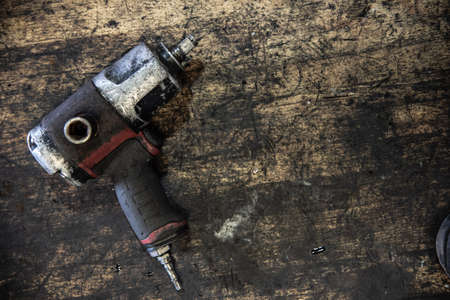 Impact wrench on a old table in workshop.の写真素材