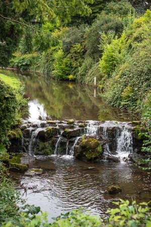Slow flowing water of narrow river in Buxton, Derbyshire, UK.の写真素材
