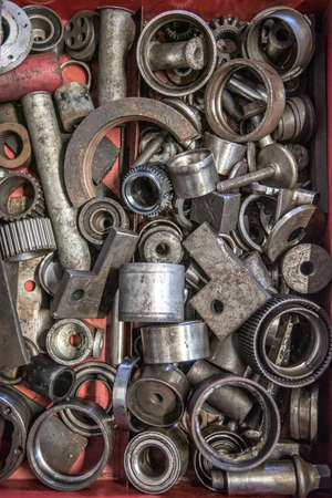 Box of random nuts and bolt, parts, washers, screws in workshop garage.