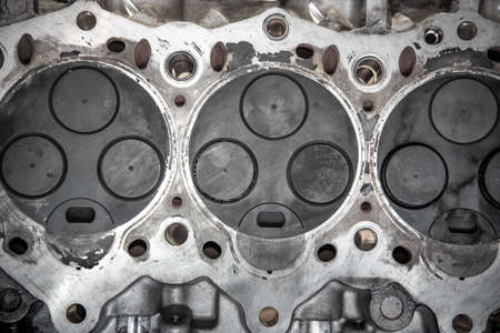 Head removed from the engine with visible three valves and burn marks.