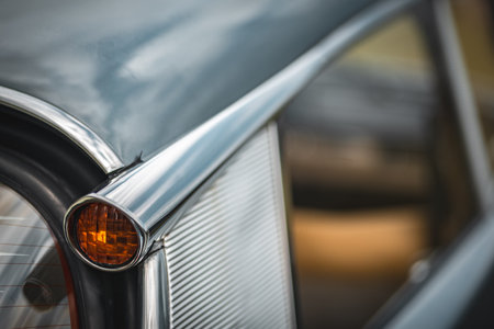 Rear quoter panel and a yellow indicator of an old classic french car on a classic car show.