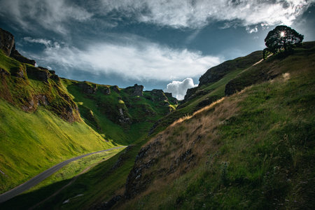 Curvy road between two hills in Yorkshire, Winnats Pass, UKの写真素材