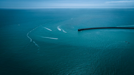 Aerial view of few boats in blue waters of Newhaven, East Sussex, UKの写真素材