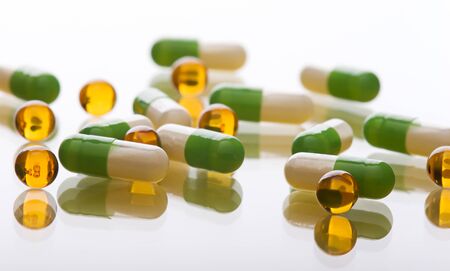 Heap of pills on a glass surfaceの写真素材