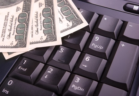 Close-up of keyboard and dollarsの写真素材