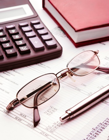 Pen,glasses,calculator and notebook close upの写真素材