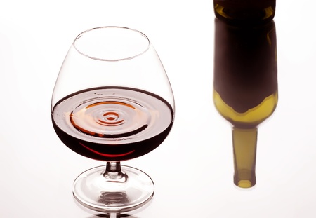 Glass about a brandy and bottle reflectionの写真素材