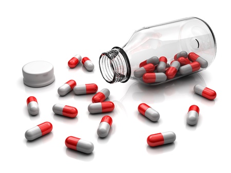 Medicament capsules from glass bottle on a white backgroundの写真素材