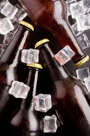Beer bottles cooled in ice cubes の写真素材