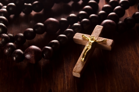 Closeup of wooden cross and rosaryの写真素材