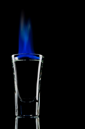Burning vodka in shot on a black backgroundの写真素材