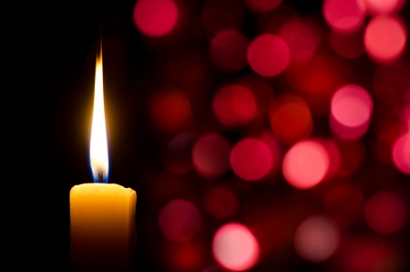 Burning candle on abstract color bacgroundの写真素材