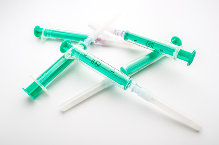 Plastic syringes with needle on white backgroundの写真素材