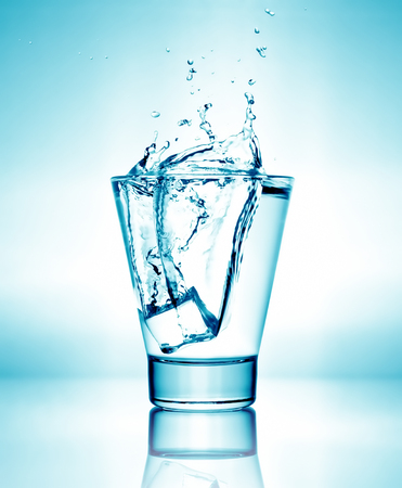 Splashing water in glassの写真素材