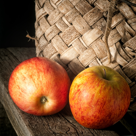 Still-life from apples and an old basketの写真素材