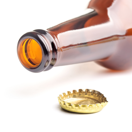 Isolated opened bottle with  crown cap on a white backgroundの写真素材
