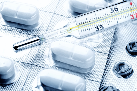 Drug pills and the mercury thermometer close upの写真素材