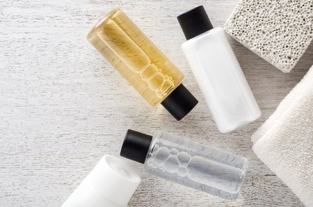 Shampoo and shower gel with towel on a tableの写真素材