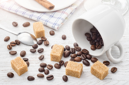 Cofee grains from white cup on a tableの写真素材