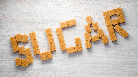 The word "sugar" composed of cane sugar piecesの写真素材