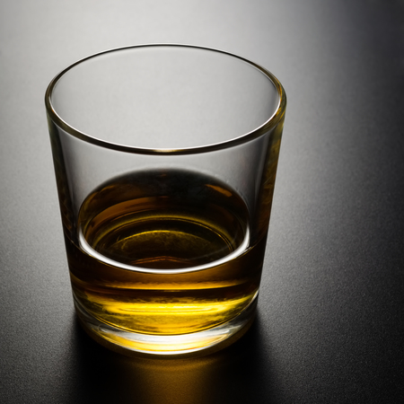 Single whisky glass on black