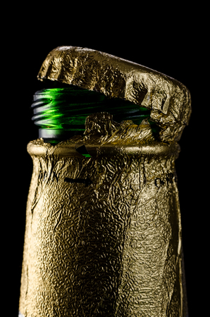 Open beer bottle with foiled capの写真素材