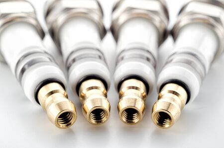Automotive four spark plugs insulators close upの写真素材