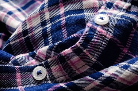 Button on a checkered shirt close-upの写真素材