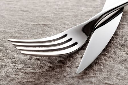 Fork and knife on a linen tablecover