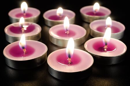 Aroma tea candles burning in darknessの写真素材