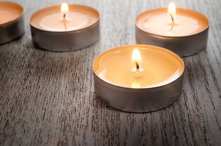 Aroma tea candles burning on woodの写真素材